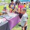 Nicole Stokes | Franklin Advocate
Bridget Griffin and Hassan Pickett check out the merchandise at one of
the booths set up at Saturday's Shop the Block in downtown Bude.